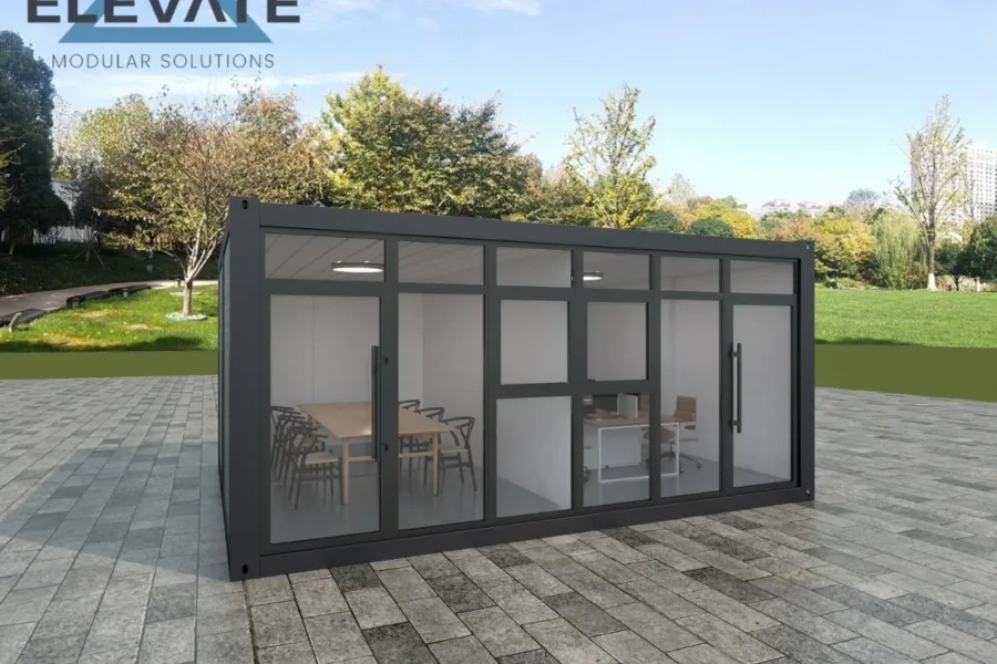 Frontal modular office with black timber facade and interior meeting room visible.
