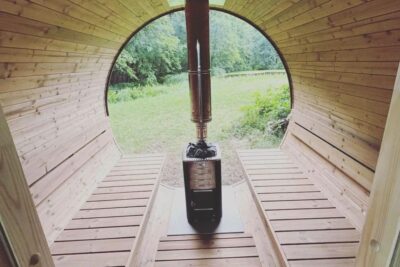 wooden home sauna with a stove in the middle